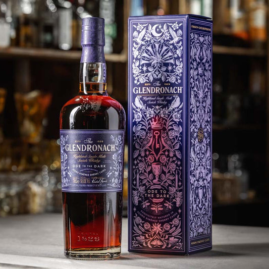 Glendronach whisky bottle and box on a bar counter with blurred shelves in the background